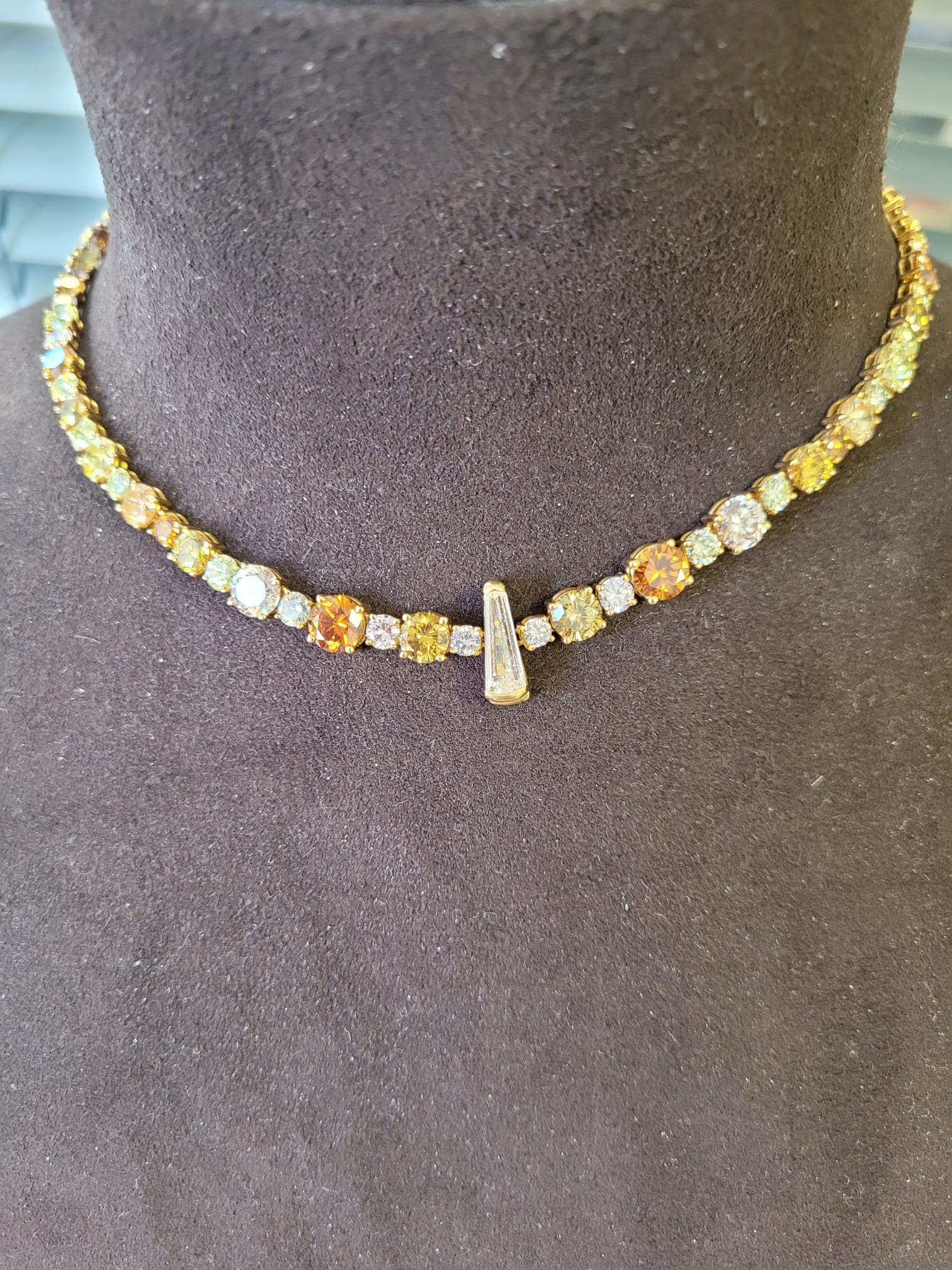 Signed high jewelry collection with emeralds, diamonds, and yellow gold